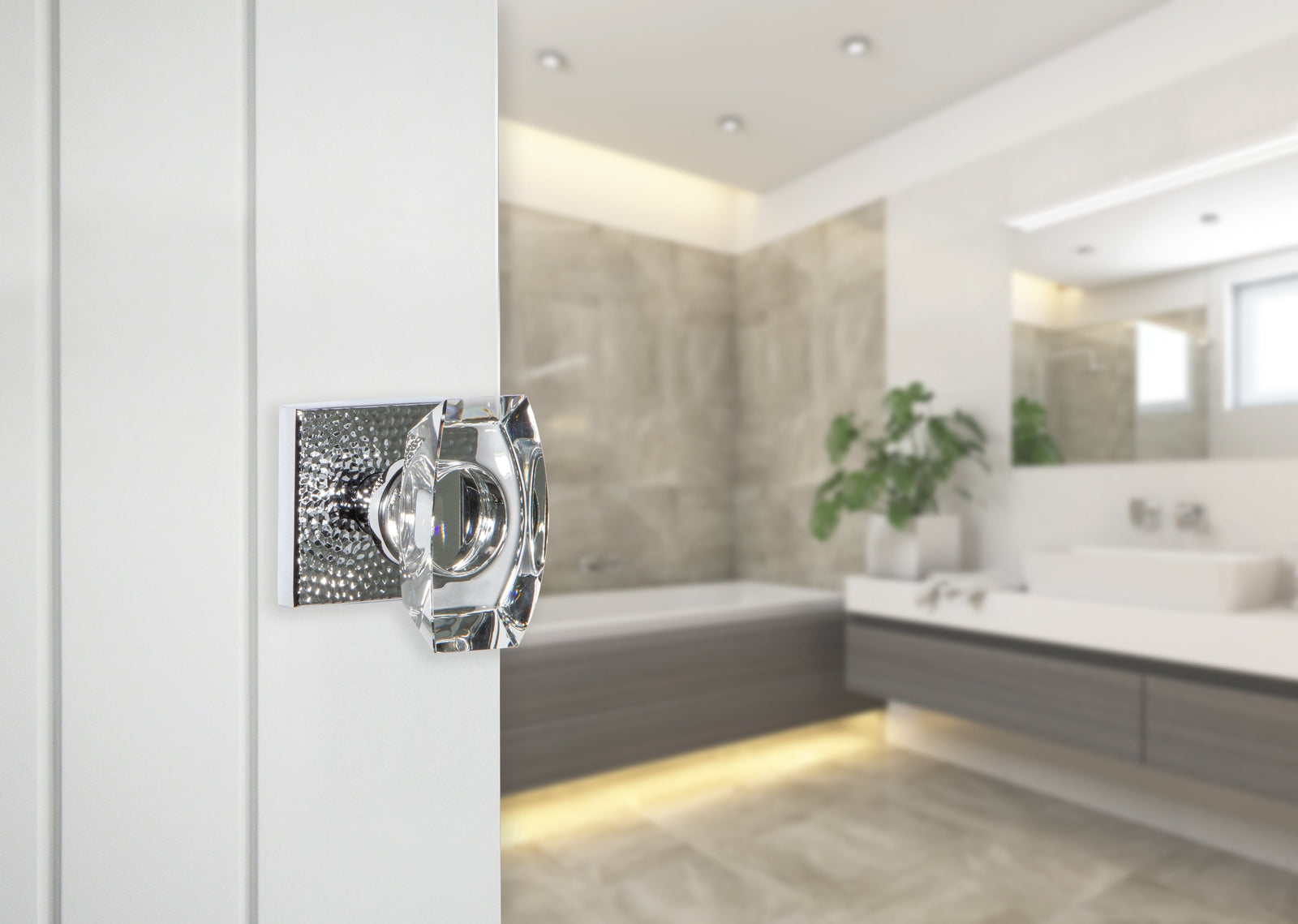 bright white modern contemporary clean bathroom with bright chrome hammered door hardware and crystal doorknob from viaggio