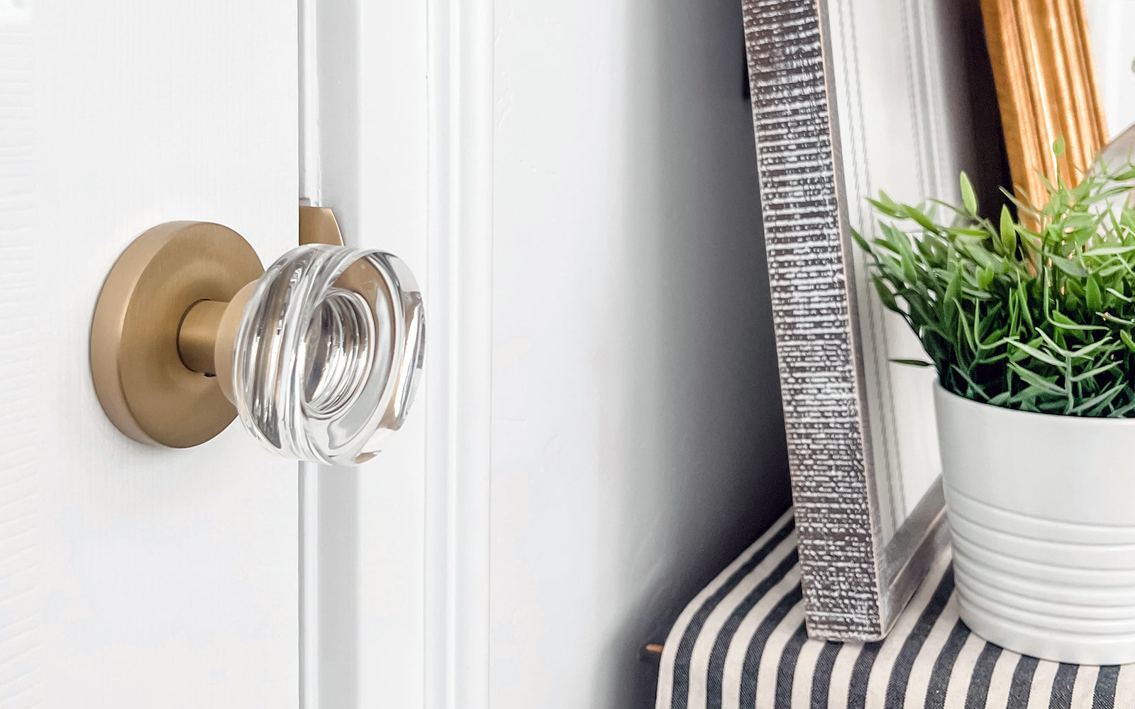 white door with luxurious satin brass door hardware and crystal doorknob from viaggio