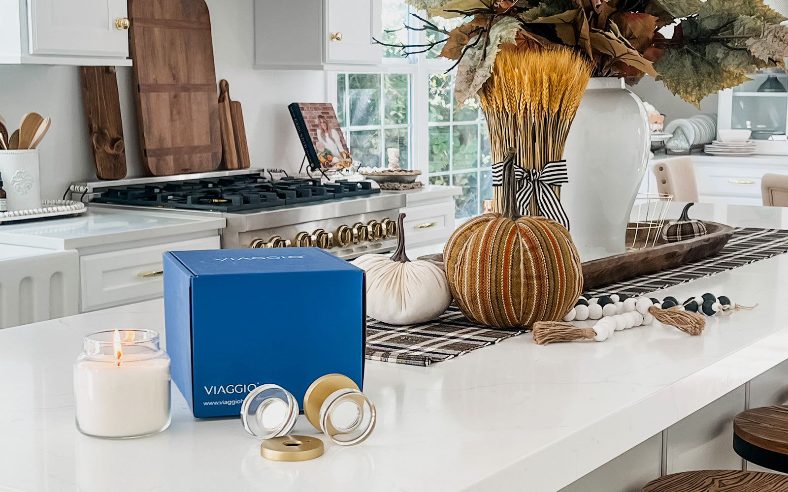 a modern kitchen decorated for fall with viaggio hardware unboxed on the counter